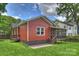 Charming home exterior with red siding, a screened porch and a small deck overlooking the backyard at 3519 Card St, Charlotte, NC 28205