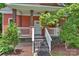 Inviting front porch with brick accents, wooden pillars, and a well-maintained stairway leading to the entrance at 3519 Card St, Charlotte, NC 28205