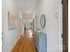Bright hallway with hardwood floors, neutral walls, and decorative furnishings leading into the main living spaces at 3519 Card St, Charlotte, NC 28205