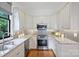 Modern kitchen with stainless steel appliances, granite countertops, and white cabinetry at 3519 Card St, Charlotte, NC 28205