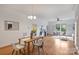 Open concept kitchen, dining room, and living room with hardwood floors and large windows at 3519 Card St, Charlotte, NC 28205