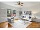 Spacious living room features hardwood floors, large windows with shutters, and a stylish seating area with modern decor at 3519 Card St, Charlotte, NC 28205