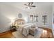 Relaxing main bedroom with hardwood floors, ceiling fan, neutral decor, and plenty of light at 3519 Card St, Charlotte, NC 28205