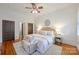 Comfortable main bedroom with hardwood floors, neutral decor, ceiling fan, and ample closet space at 3519 Card St, Charlotte, NC 28205