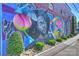Vibrant mural on a brick building featuring colorful portraits and artistic elements at 3519 Card St, Charlotte, NC 28205