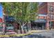 Street view of Cabo Fish Taco restaurant with outdoor seating and beautiful trees in the front at 3519 Card St, Charlotte, NC 28205