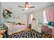 Bright bedroom with unique decor, hardwood floors, and ceiling fan at 3612 Trent St, Charlotte, NC 28209