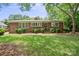 Charming brick home with a well-manicured lawn and lush landscaping in a desirable neighborhood at 3612 Trent St, Charlotte, NC 28209