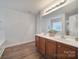 Bathroom with double sink vanity, wood-look flooring, and plenty of counter space at 3908 Parkers Ferry Rd, Fort Mill, SC 29715