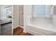 Bathroom with separate tub and shower, wood-look floor, and natural light at 3908 Parkers Ferry Rd, Fort Mill, SC 29715