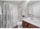 Bright bathroom features a shower and tub combination with a decorative shower curtain and wood-style floor at 3908 Parkers Ferry Rd, Fort Mill, SC 29715