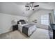 Bright bedroom with a ceiling fan, window, carpet and a neatly made bed with decorative pillows at 3908 Parkers Ferry Rd, Fort Mill, SC 29715
