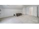 Expansive carpeted bonus room featuring a vaulted ceiling and a nearby door at 3908 Parkers Ferry Rd, Fort Mill, SC 29715