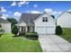 Charming two-story home with a well-manicured lawn, a two-car garage, and traditional architectural details at 3908 Parkers Ferry Rd, Fort Mill, SC 29715