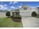 Charming two-story home with manicured lawn and a two-car garage provides curb appeal at 3908 Parkers Ferry Rd, Fort Mill, SC 29715