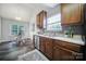 Bright kitchen boasts stainless appliances, wood cabinetry, and adjacent breakfast nook with large window at 3908 Parkers Ferry Rd, Fort Mill, SC 29715