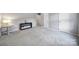 Spacious carpeted living room featuring a side table with a lamp and two white doors at 3908 Parkers Ferry Rd, Fort Mill, SC 29715