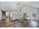 Open-concept living room with fireplace, vaulted ceiling, and view into dining and kitchen areas at 3908 Parkers Ferry Rd, Fort Mill, SC 29715