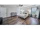 Main bedroom with wood-look flooring, soft decor, and lots of natural light at 3908 Parkers Ferry Rd, Fort Mill, SC 29715