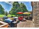 Back deck with outdoor kitchen setup, seating, and beautiful green trees in the background at 3913 Widgeon Way, Waxhaw, NC 28173