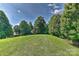 Large, well-manicured backyard with healthy green grass and mature trees providing shade and privacy at 3913 Widgeon Way, Waxhaw, NC 28173