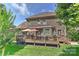 Landscaped backyard with lush lawn, a spacious deck, and a well-maintained brick home at 3913 Widgeon Way, Waxhaw, NC 28173