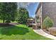 Brick home features a spacious backyard, wooden deck with seating, and lush green landscaping at 3913 Widgeon Way, Waxhaw, NC 28173