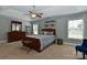 Bedroom with neutral tones, a ceiling fan, two windows, and a wooden dresser at 3913 Widgeon Way, Waxhaw, NC 28173
