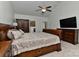 Bedroom featuring a ceiling fan and a large bed with an en suite bathroom entrance at 3913 Widgeon Way, Waxhaw, NC 28173