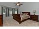 Bright bedroom featuring a ceiling fan, and a large wooden bed with detailed wooden bedside tables at 3913 Widgeon Way, Waxhaw, NC 28173