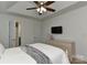 Bright bedroom featuring a ceiling fan, TV, and a comfortable bed with a gray throw blanket at 3913 Widgeon Way, Waxhaw, NC 28173