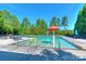 Community pool with playful water features and ample lounge seating surrounded by mature trees at 3913 Widgeon Way, Waxhaw, NC 28173