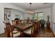 Dining room featuring a modern chandelier over a long dining table with ten upholstered chairs at 3913 Widgeon Way, Waxhaw, NC 28173