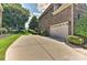 Spacious driveway leading to a two-car garage with manicured landscaping and brick exterior at 3913 Widgeon Way, Waxhaw, NC 28173