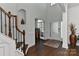 Elegant foyer featuring hardwood floors, staircase with dark wood railing and a decorative glass door at 3913 Widgeon Way, Waxhaw, NC 28173