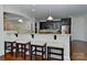 Eat-in kitchen boasting a breakfast bar, dark cabinetry and granite countertops at 3913 Widgeon Way, Waxhaw, NC 28173