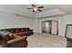 Open living room featuring a ceiling fan, and a view of the hallway and stairway at 3913 Widgeon Way, Waxhaw, NC 28173
