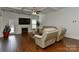 Bright living room with coffered ceilings, fireplace, and gleaming hardwood floors at 3913 Widgeon Way, Waxhaw, NC 28173