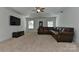 Living room featuring a ceiling fan, large windows and a leather sofa at 3913 Widgeon Way, Waxhaw, NC 28173
