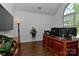 Well-lit office with hardwood floors, large window, a dark wooden desk and vaulted ceilings at 3913 Widgeon Way, Waxhaw, NC 28173