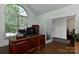 Sunlit office with dark wood desk, hardwood floors, large window with transom and a French door at 3913 Widgeon Way, Waxhaw, NC 28173