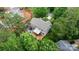 Aerial view of home, deck, and patio surrounded by mature trees at 4007 Lake Shore S Rd, Denver, NC 28037