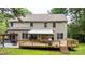 Expansive backyard features a large wooden deck with a retractable awning, ideal for entertaining and relaxation at 4007 Lake Shore S Rd, Denver, NC 28037