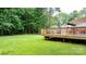 Expansive backyard features a well-maintained lawn and wooden deck overlooking the trees at 4007 Lake Shore S Rd, Denver, NC 28037