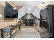 Finished basement bar with mini fridge, sink, bar seating, tv and decorative brick wall at 4007 Lake Shore S Rd, Denver, NC 28037