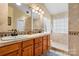Bathroom featuring double sinks, a walk-in shower, and tiled floors at 4007 Lake Shore S Rd, Denver, NC 28037