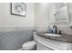Charming bathroom featuring a stylish vanity, granite countertop, decorative tile, and updated fixtures at 4007 Lake Shore S Rd, Denver, NC 28037