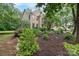 Brick house featuring a landscaped yard with flowering trees and an attached garage at 4007 Lake Shore S Rd, Denver, NC 28037