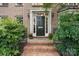 Elegant brick home entrance with a black door and decorative accents at 4007 Lake Shore S Rd, Denver, NC 28037