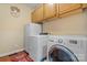 Well-equipped laundry room featuring modern washer, dryer, and ample overhead cabinet storage at 4007 Lake Shore S Rd, Denver, NC 28037